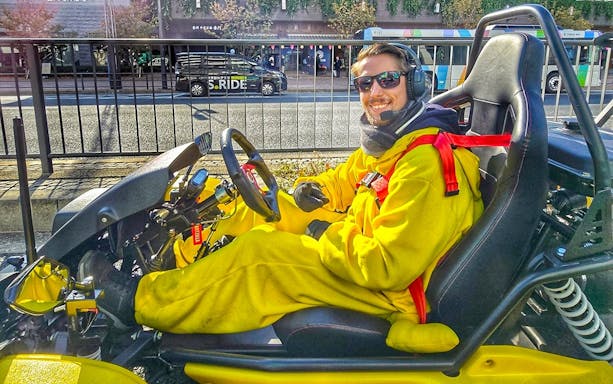 Person in costume driving a go-kart on Tokyo street during Skytree, Ginza, and Imperial Palace tour.