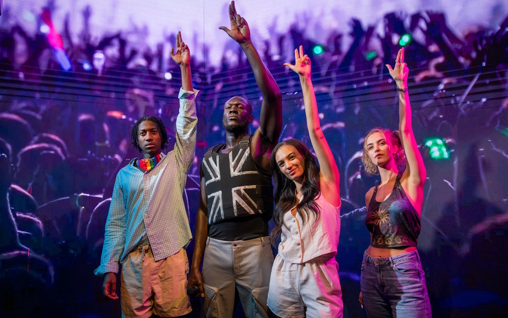 Stormzy wax figure with three people at Madame Tussauds London.