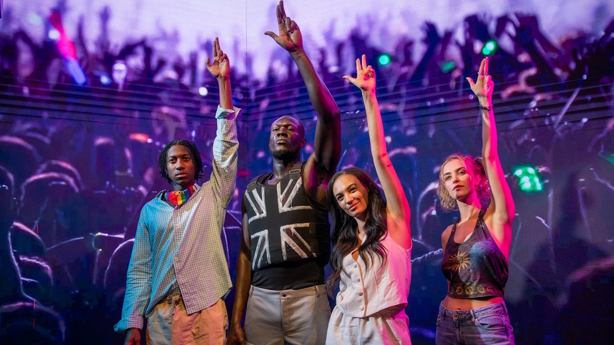 Stormzy wax figure with three people at Madame Tussauds London.