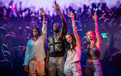 Stormzy wax figure with three people at Madame Tussauds London.