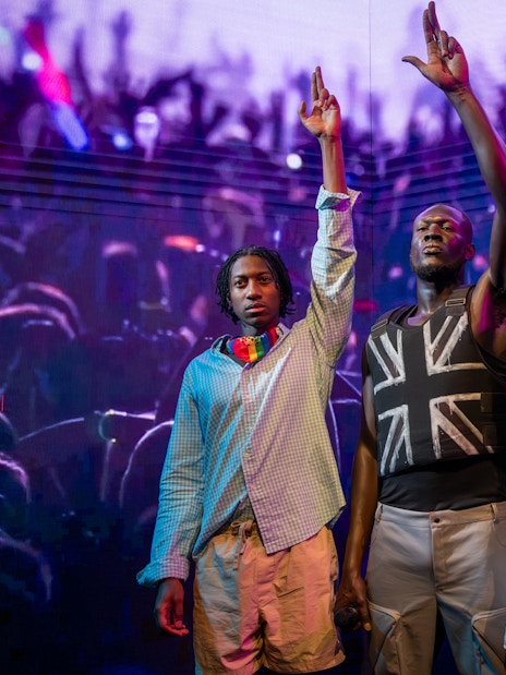 Stormzy wax figure with three people at Madame Tussauds London.