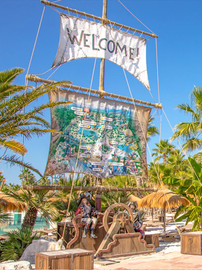 Caribe Bay entrance with pirate theme and park map display.