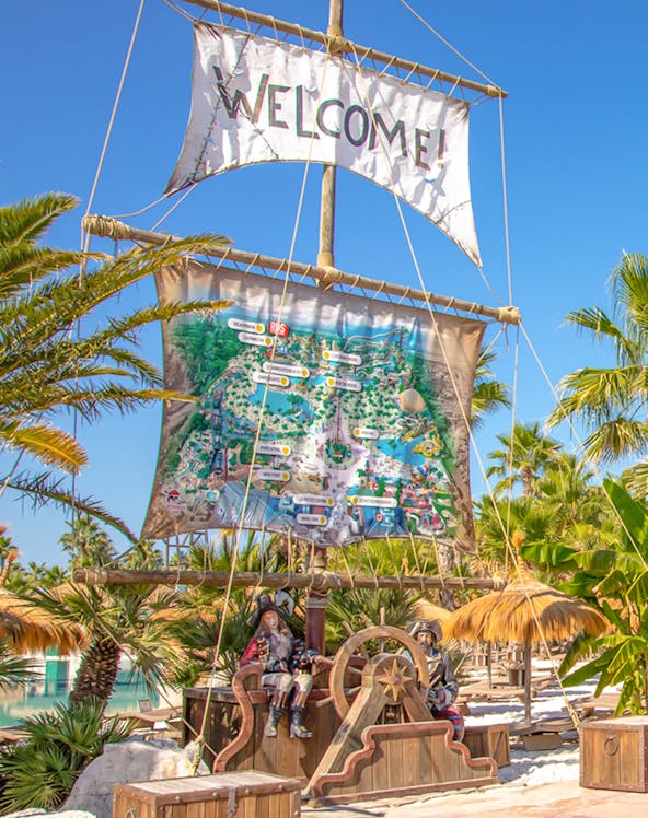 Caribe Bay entrance with pirate theme and park map display.