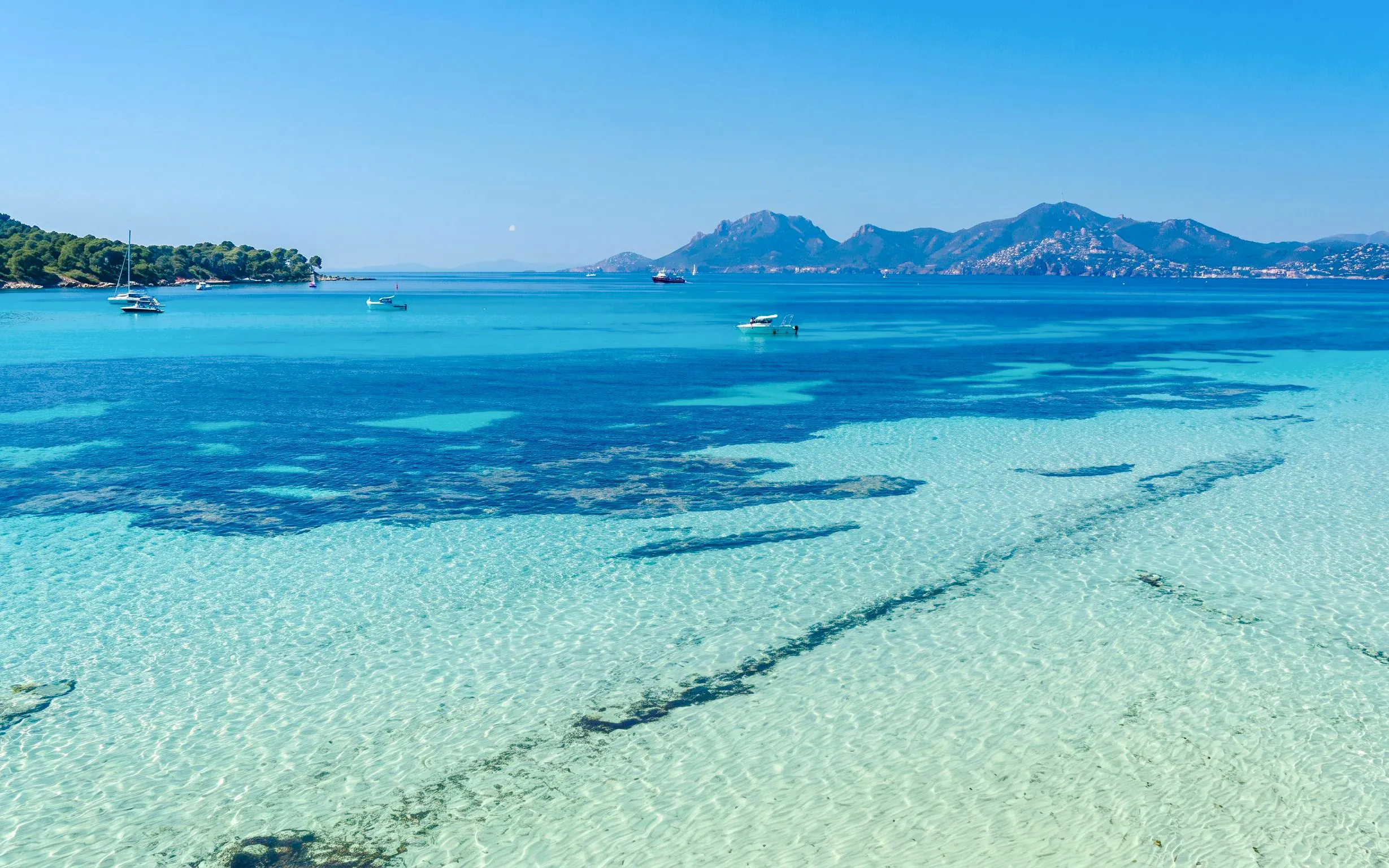 Jet skiing on clear waters with distant mountains in Cannes, French Riviera, France.