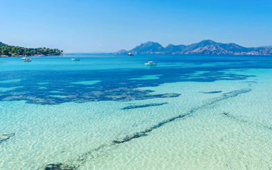 Jet skiing on clear waters with distant mountains in Cannes, French Riviera, France.