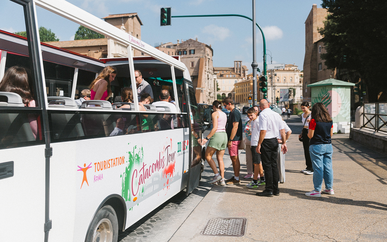 Tourists boarding a bus for a guided tour of the Catacombs in Rome.