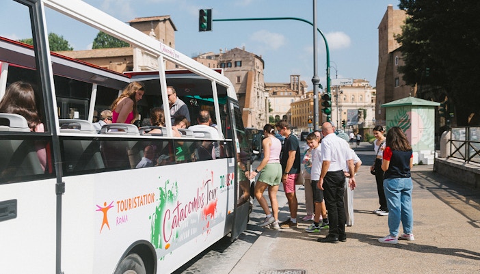 Group of tourists exploring the ancient Catacombs in Rome, guided tour with Capuchin Crypt Entry