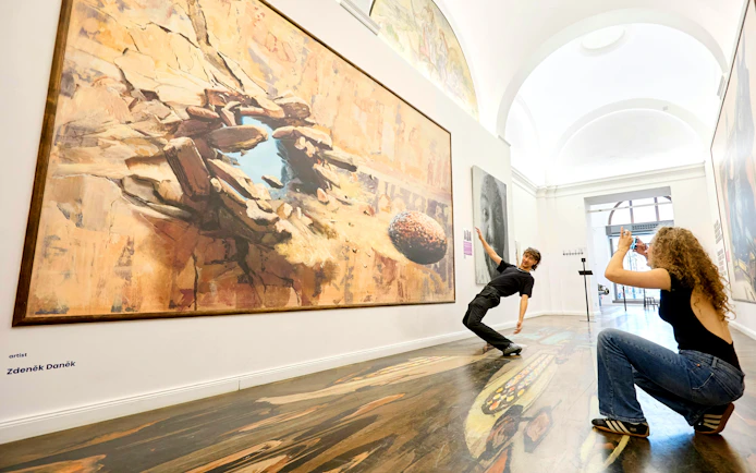 Visitors interacting with illusion art at IAM Illusion Art Museum, Prague.