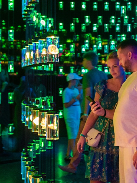 Visitors exploring the Library of Life exhibit at Dubai Museum of the Future, surrounded by illuminated displays.