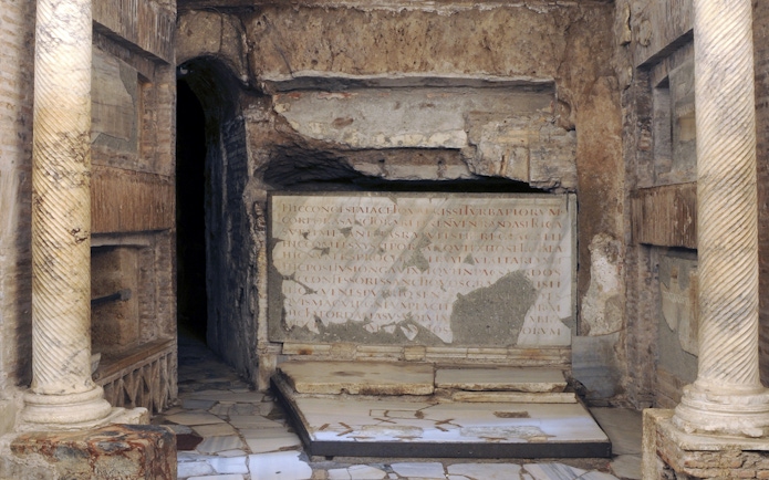 Ancient stone inscriptions and columns in the Catacombs of St Callixtus, Rome.
