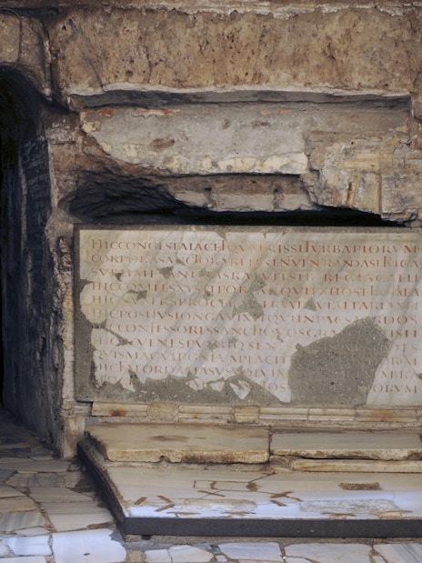 Ancient stone inscriptions and columns in the Catacombs of St Callixtus, Rome.