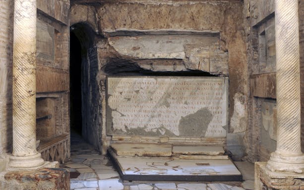 Ancient stone inscriptions and columns in the Catacombs of St Callixtus, Rome.
