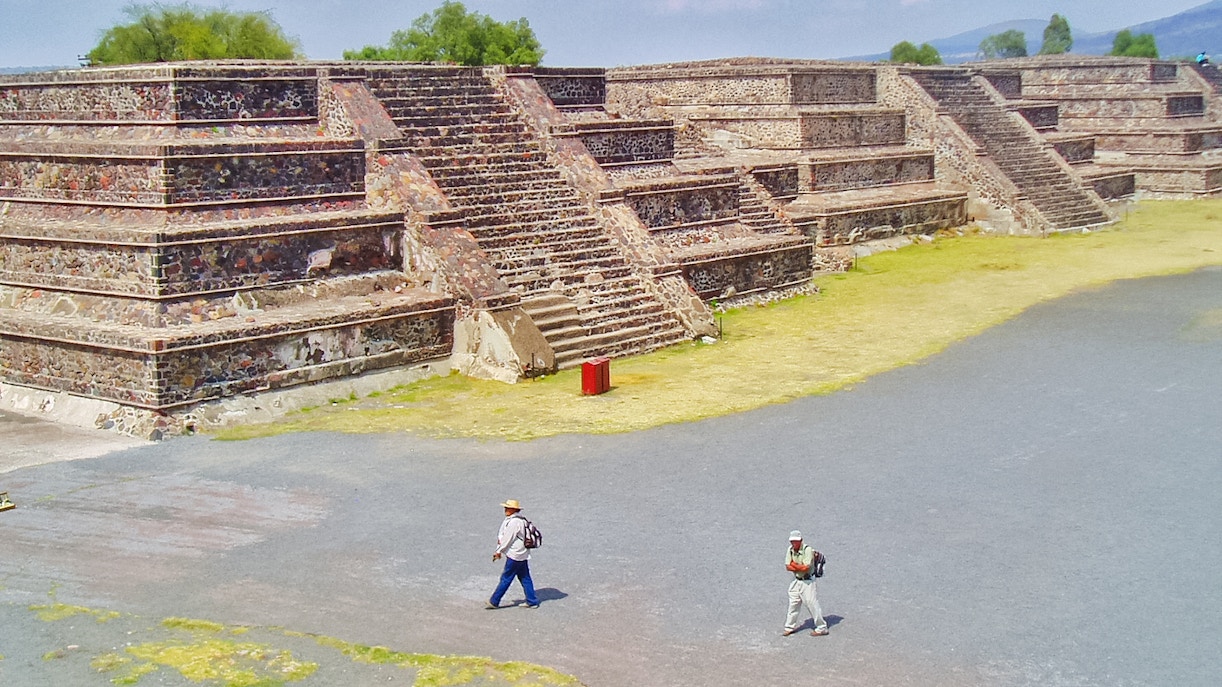 Teotihuacan Pyramid with tourists walking on a guided tour in Mexico.
