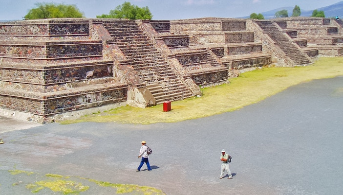 Teotihuacan Pyramid with tourists walking on a guided tour in Mexico.