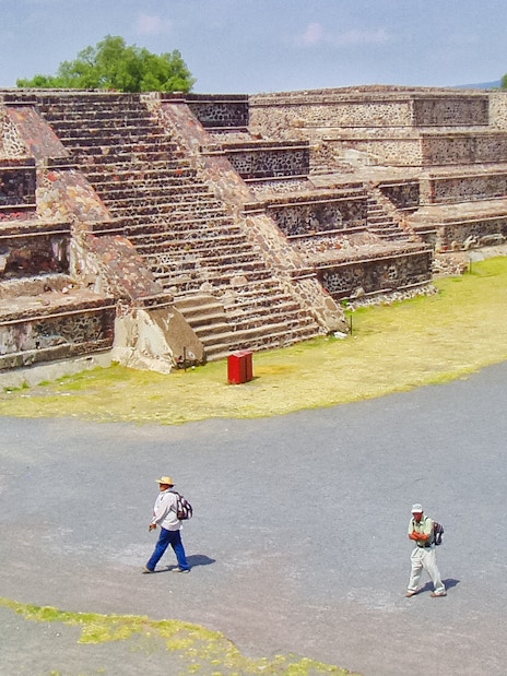 Teotihuacan Pyramid with tourists walking on a guided tour in Mexico.
