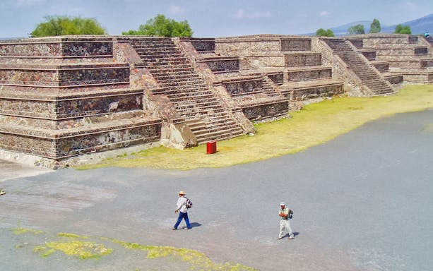 Teotihuacan pyramids with tourists on a guided walking tour in Mexico.