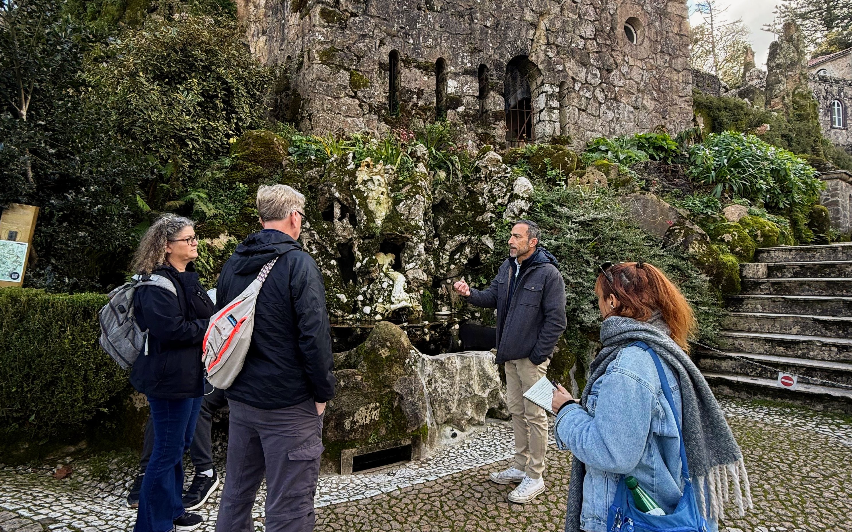 Tourists with guide at Quinta da Regaleira tower, Sintra, Portugal.