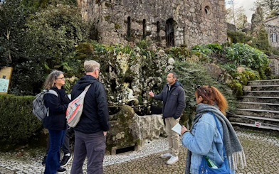 Tourists with guide at Quinta da Regaleira tower, Sintra, Portugal.