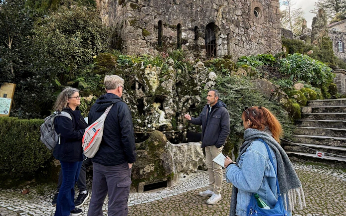 Tourists with guide at Quinta da Regaleira tower, Sintra, Portugal.