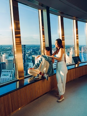 Couple enjoying view from Sydney Tower Eye observation deck.