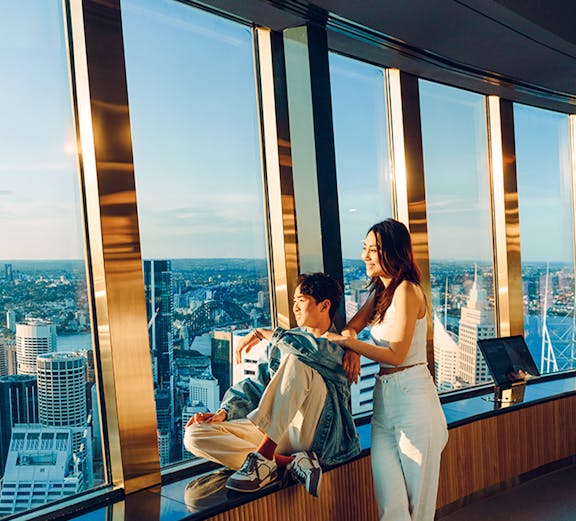 Couple enjoying view from Sydney Tower Eye observation deck.