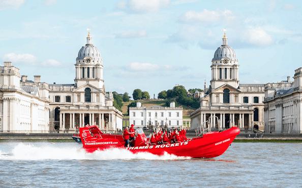 Thames speed boat passing by the Old Royal Naval College in London.
