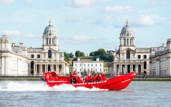 Thames speed boat passing by the Old Royal Naval College in London.