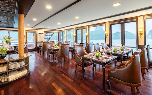 Restaurant dining area on Amanda Luxury Cruise with elegant tables and sea view.