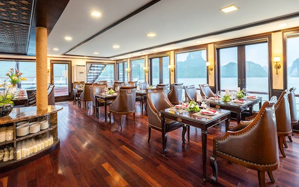 Restaurant dining area on Amanda Luxury Cruise with elegant tables and sea view.