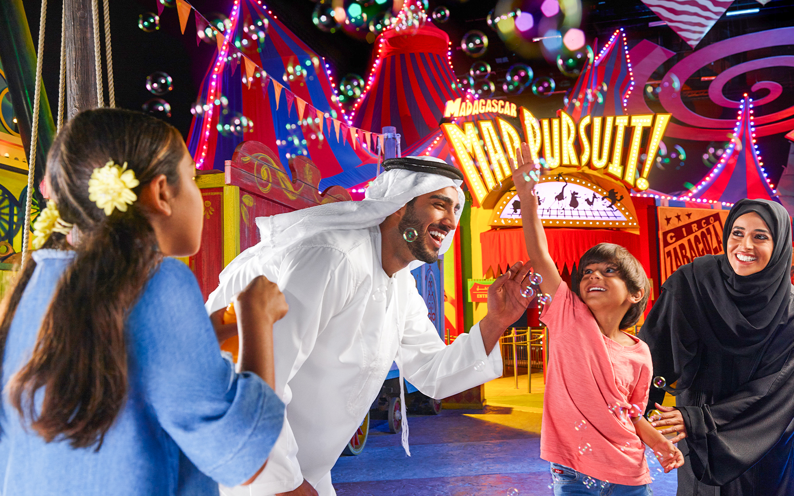 Roller coaster at MOTIONGATE™ Dubai theme park with vibrant lights and limited time ticket offer.
