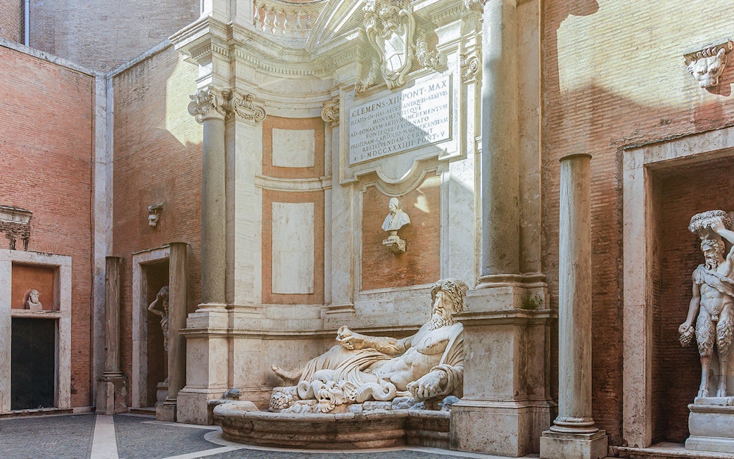 River god statue in Capitoline Museums courtyard, Rome.