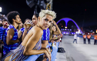 Spectators enjoying Rio Carnival 2027 from VIP box at Marquês de Sapucaí, Rio de Janeiro.