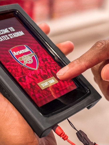 Touchscreen device displaying Arsenal FC Emirates Stadium tour start page.