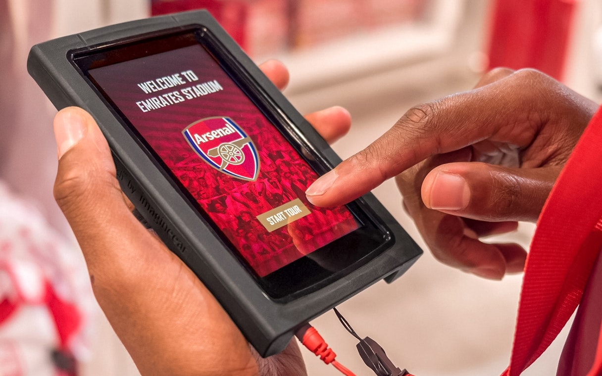 Touchscreen device displaying Arsenal FC Emirates Stadium tour start.