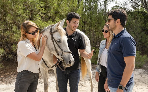 Group enjoying horse riding experience in Comporta during Lisbon tour.
