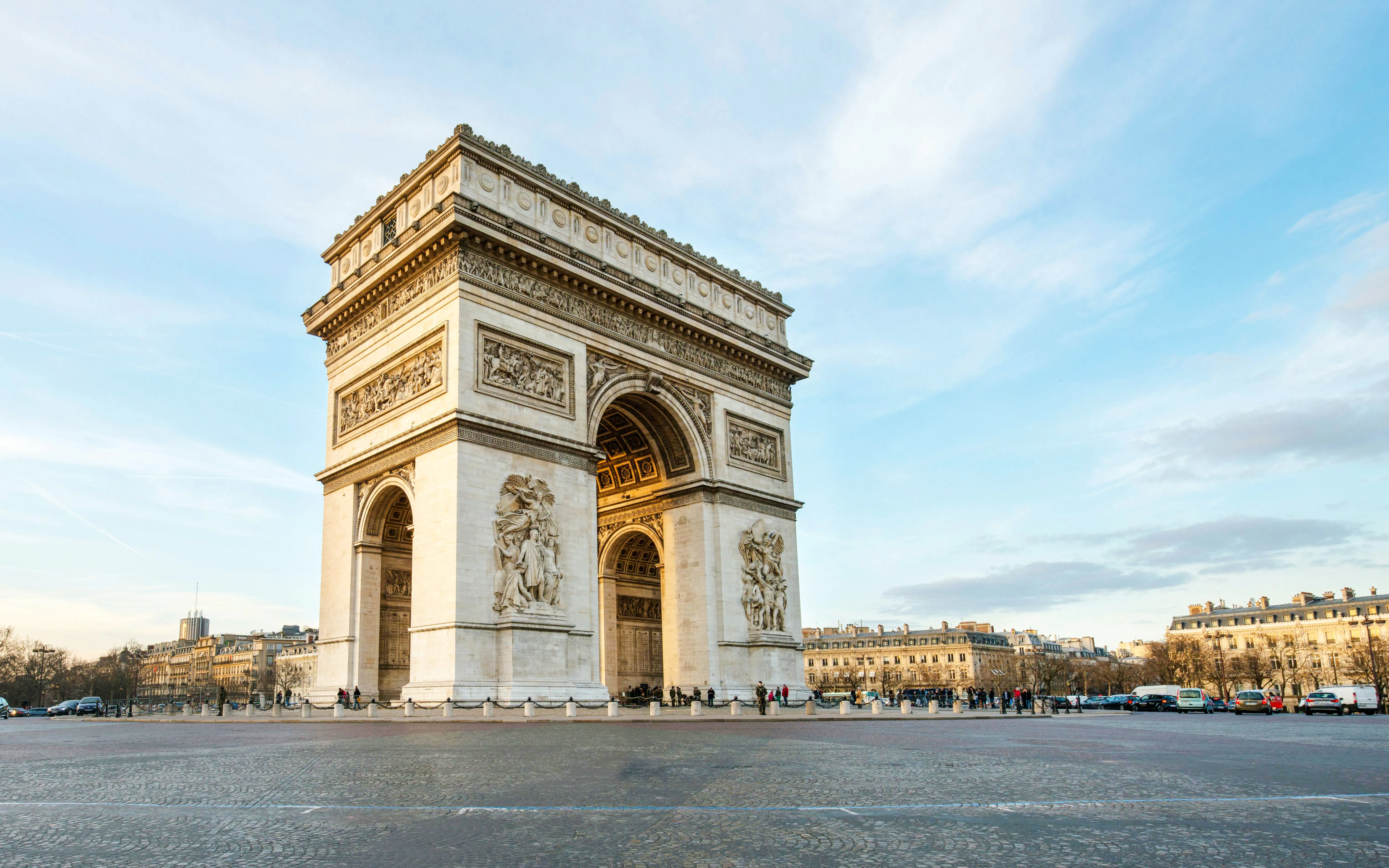 Arc de Triomphe in Paris, France, viewed from a distance on a clear day.