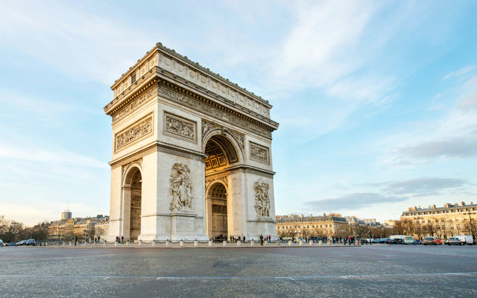 Arc de Triomphe in Paris, France, viewed from a distance on a clear day.