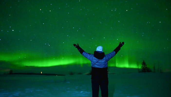 Northern Lights over Tromsø with photographer capturing aurora borealis in Norway.