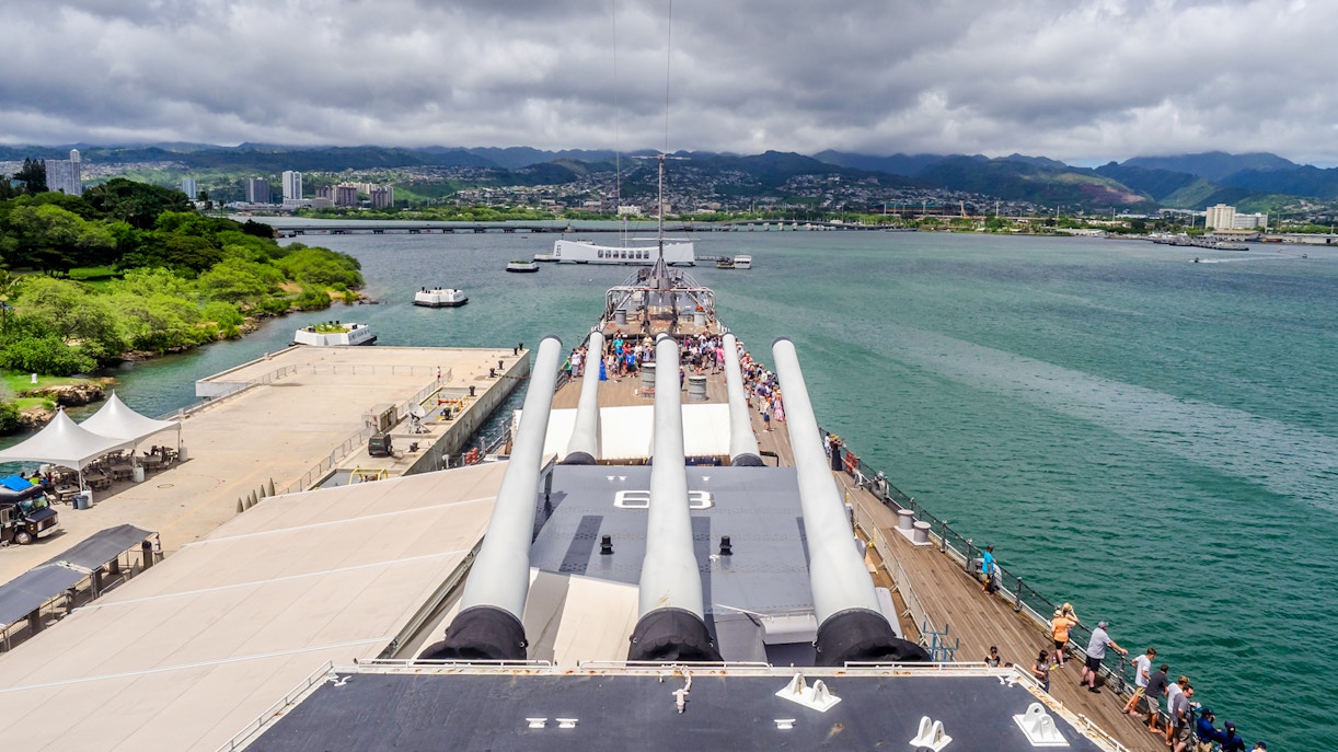 USS Missouri battleship docked at Pearl Harbor, USA, with visitors exploring the historic naval site.