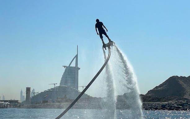 Flyboarding in Dubai with Burj Al Arab in the background.