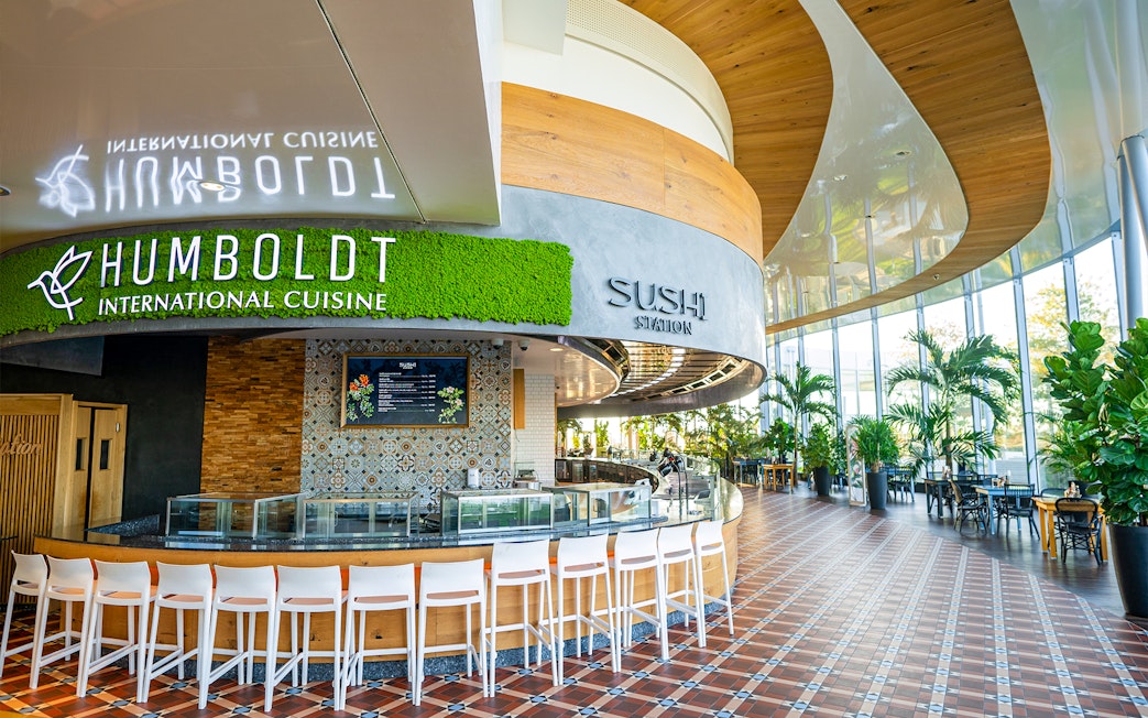 Sushi restaurant interior at Therme Bucuresti with seating and greenery.