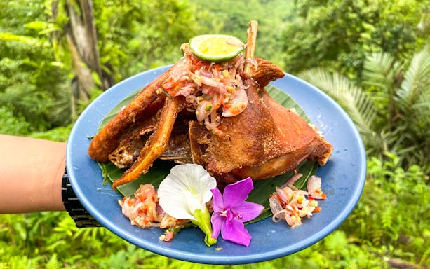 Balinese dish with sambal and flowers on a blue plate, Bali Farm Cooking Class.