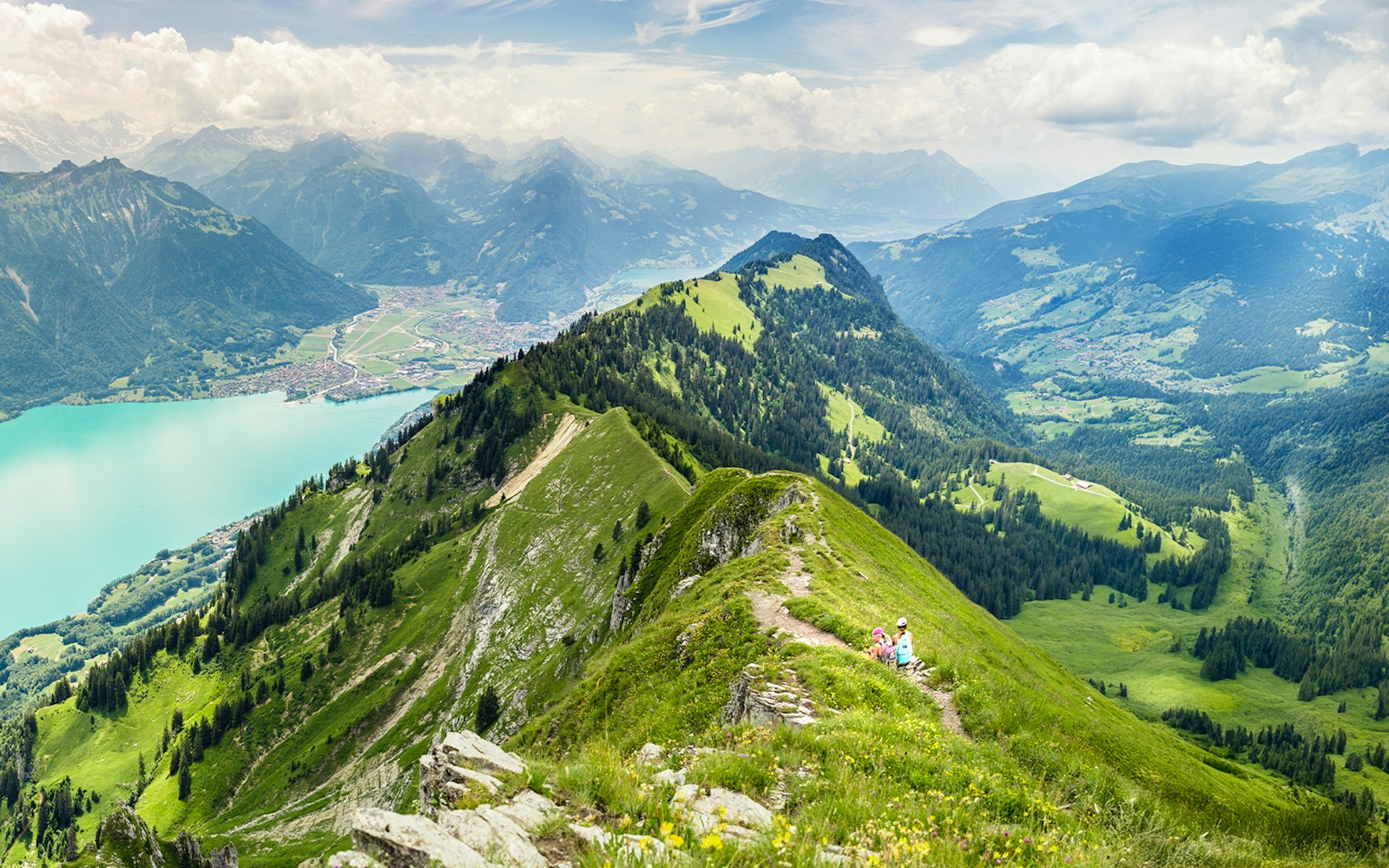 Hikers on a ridge trail from Augstmatthorn to Harder Kulm, overlooking Lake Brienz, Interlaken.