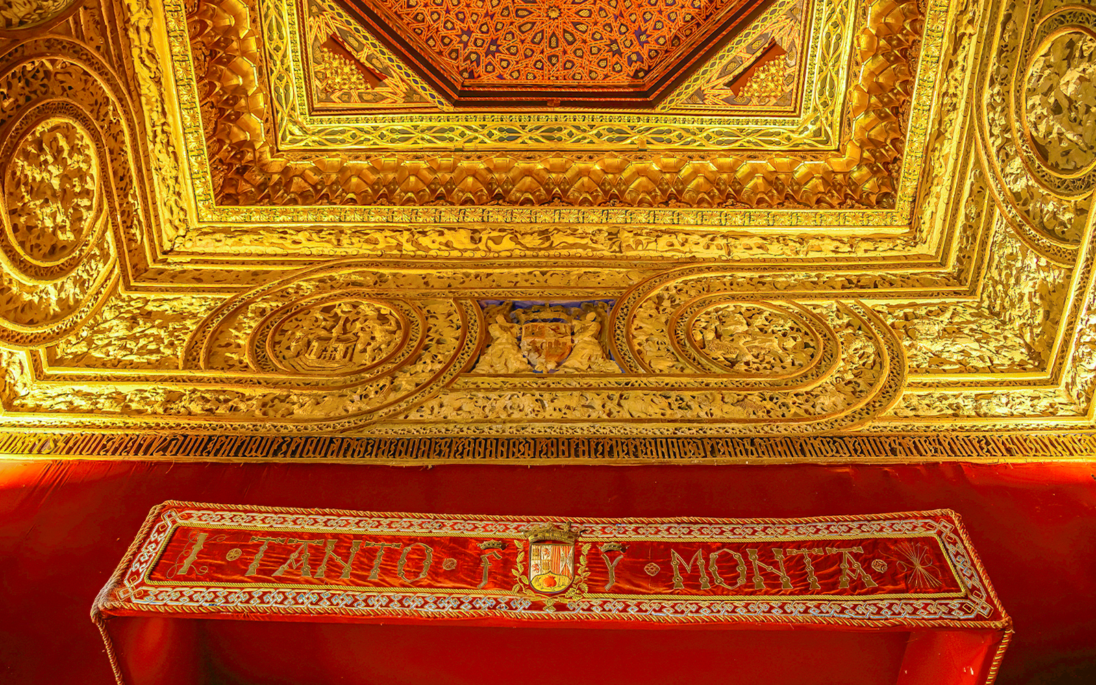 Ornate gold ceiling with intricate carvings at Alcazar of Segovia, Spain.