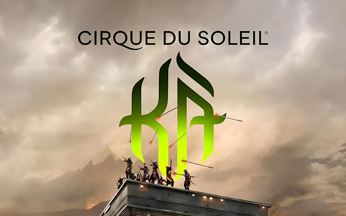 Performers on a rooftop with Cirque du Soleil KÀ logo in the background.