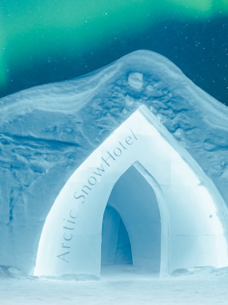 Exterior of Arctic SnowHotel under northern lights.