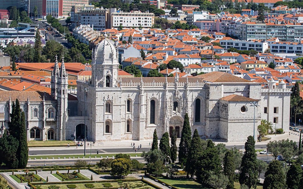 Jerónimos Monastery in Lisbon with surrounding gardens and cityscape.