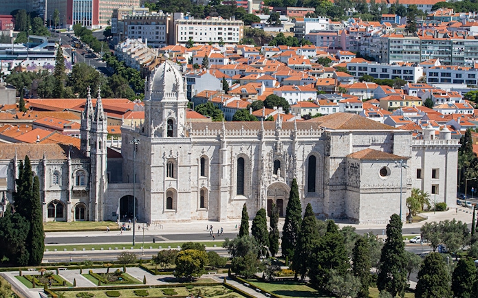 Jerónimos Monastery in Lisbon with surrounding gardens and cityscape.