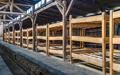 Wooden barracks interior at Auschwitz-Birkenau, part of the guided tour experience.