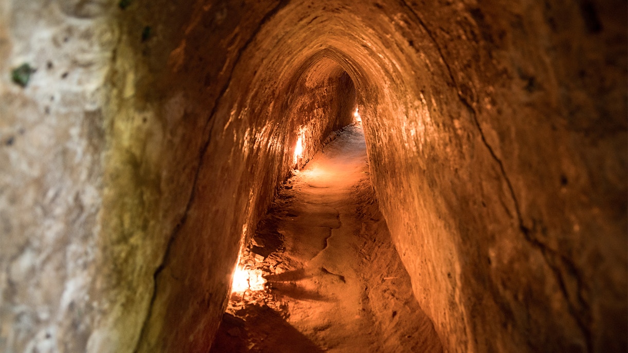 Cu Chi Tunnels entrance with tourists exploring the historic site in Ho Chi Minh City, Vietnam.